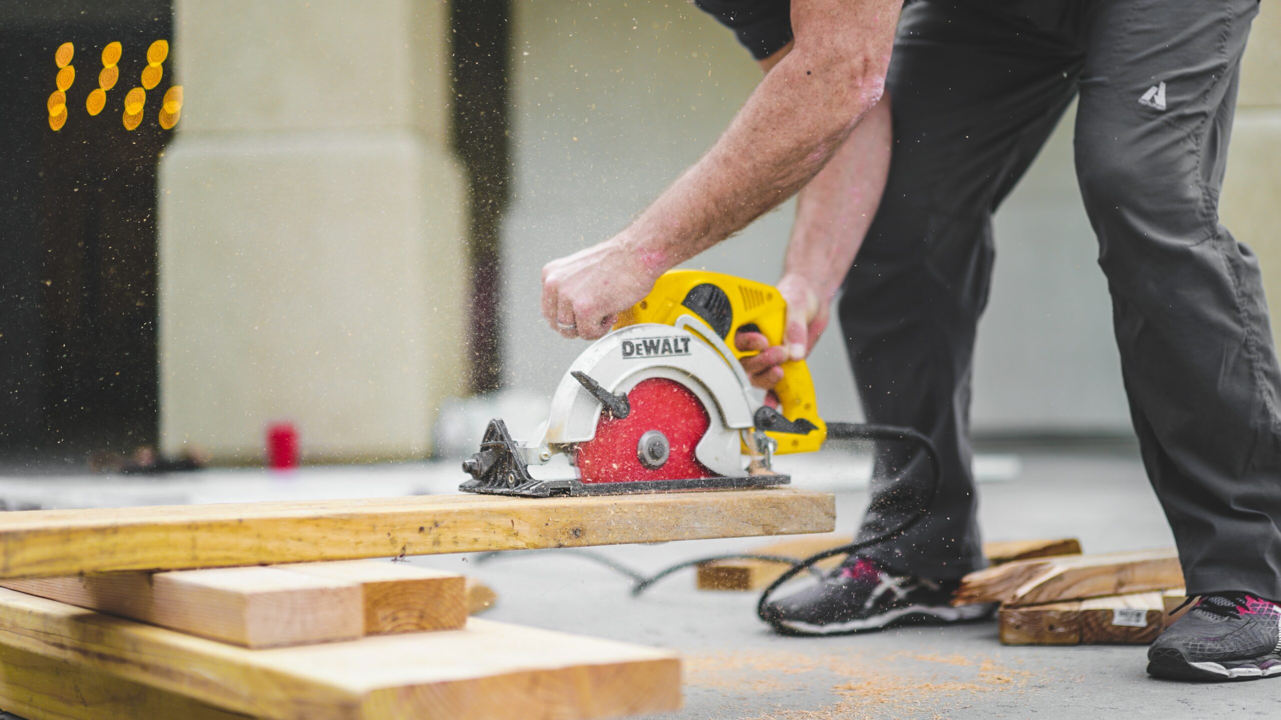 man using an electric saw which is a manual handling construction based hazard