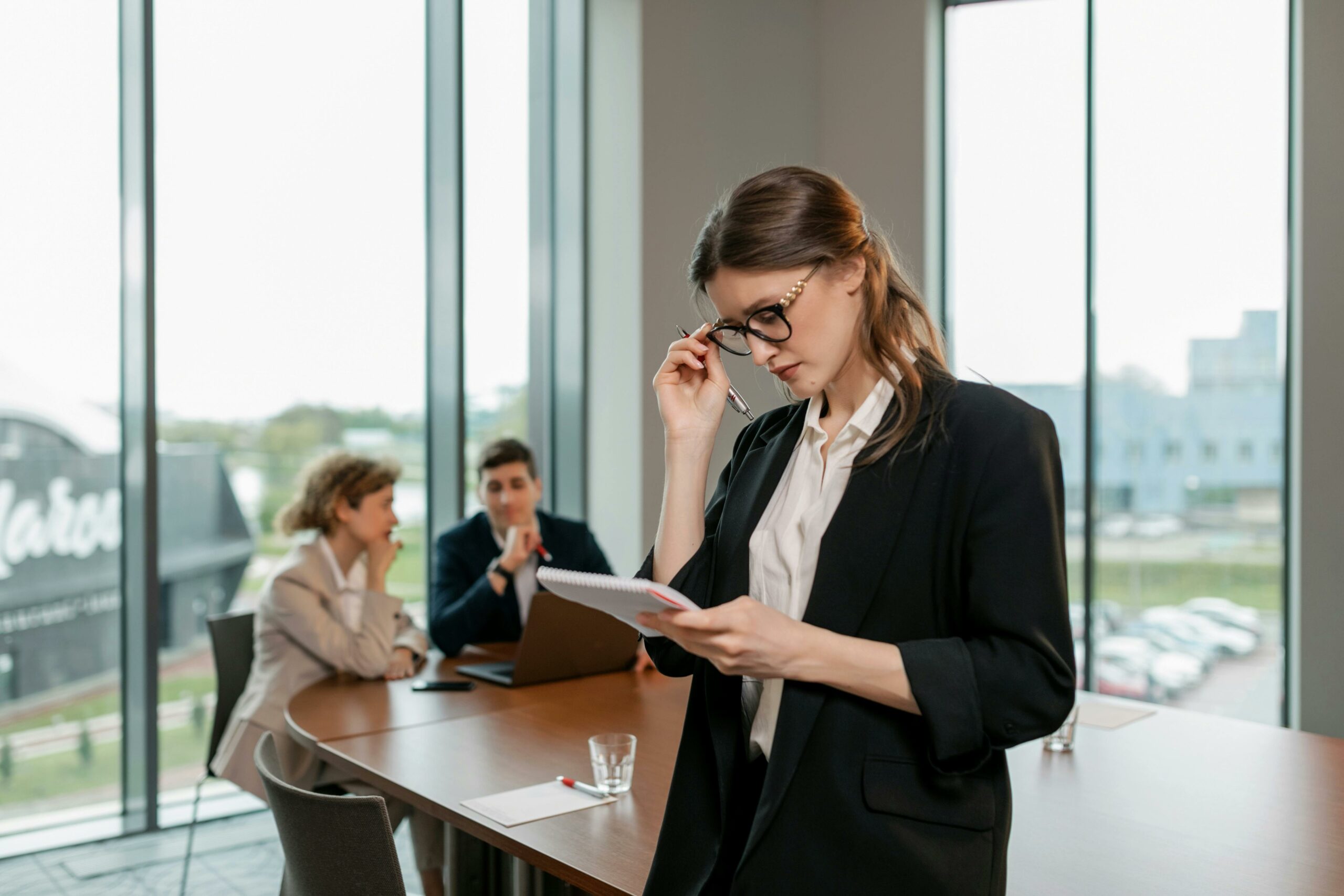 woman holding a clipboard thinking about employers' responsibilities for health and safety